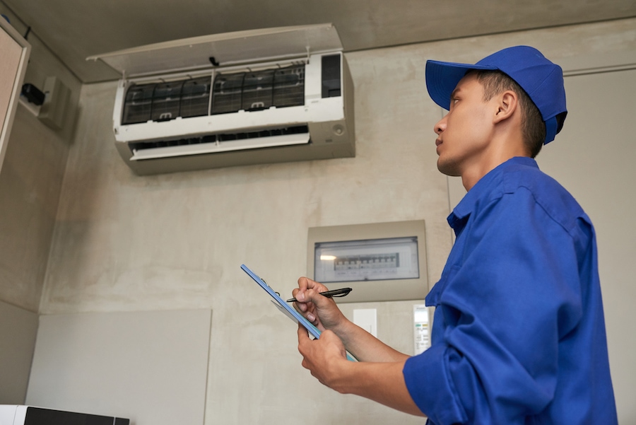 Service worker writing to do list when examining kitchen of client.