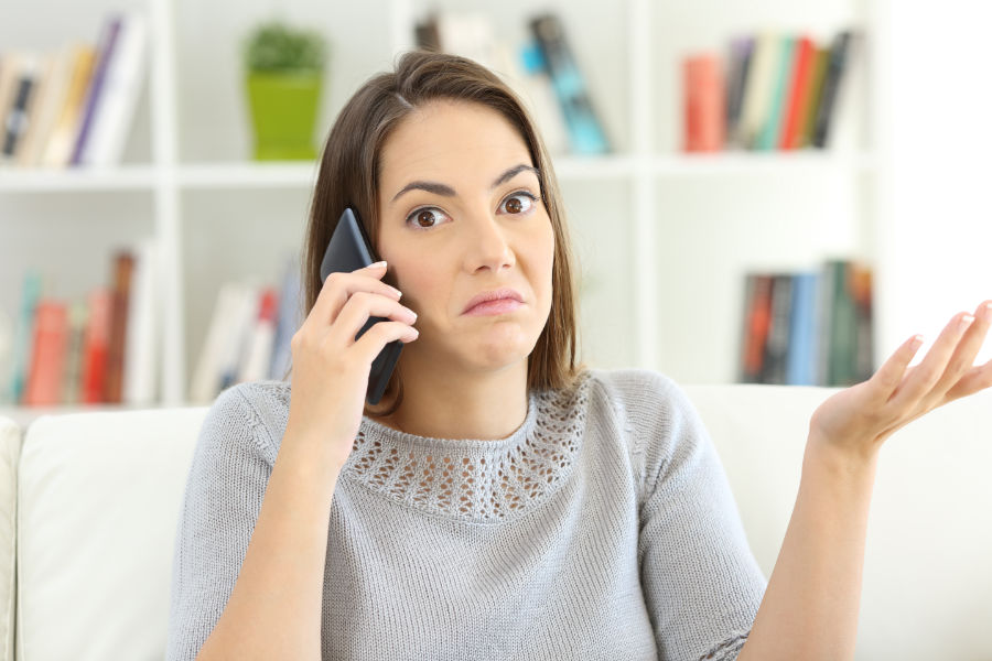 Confused lady on her cell phone.